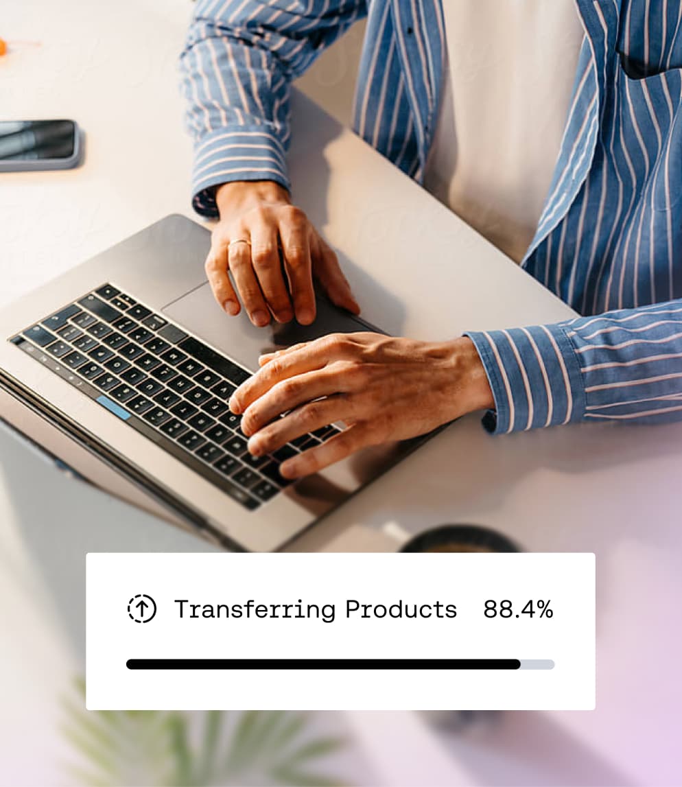 Person typing on laptop with Transferring Products progress bar overlay.