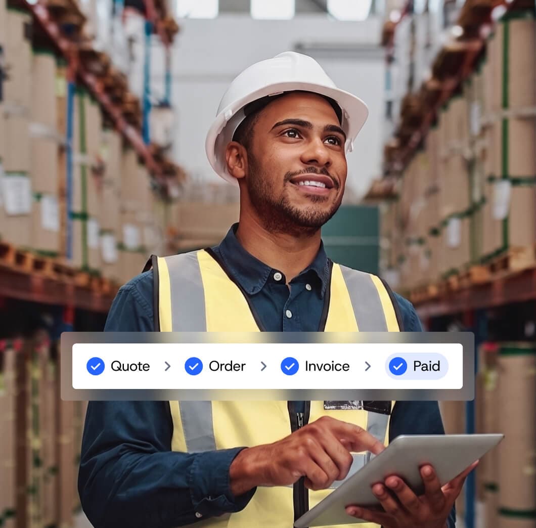 Warehouse manager holding a tablet with Quote, Order, Invoice, and Paid B2B workflow steps.